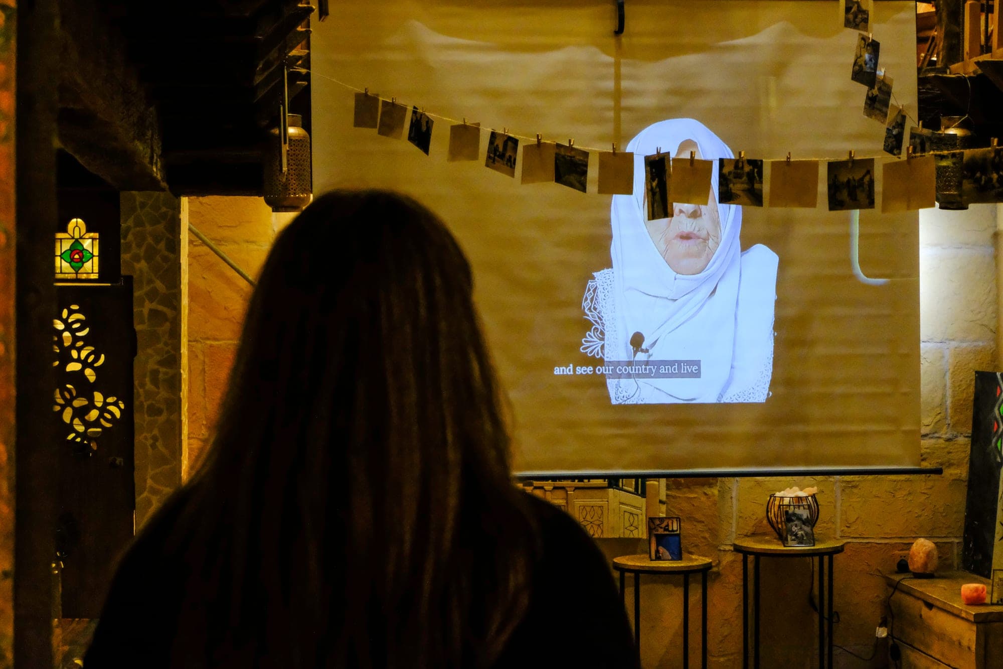 An audience watching a film projected onto a screen.